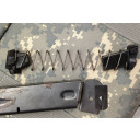 The block installs from the bottom of the spring. The metal locking plate sits under the block. Slide the floor plate closed as normal.  (Old version pictured)