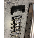 Installs under the follower at the top of the magazine. 